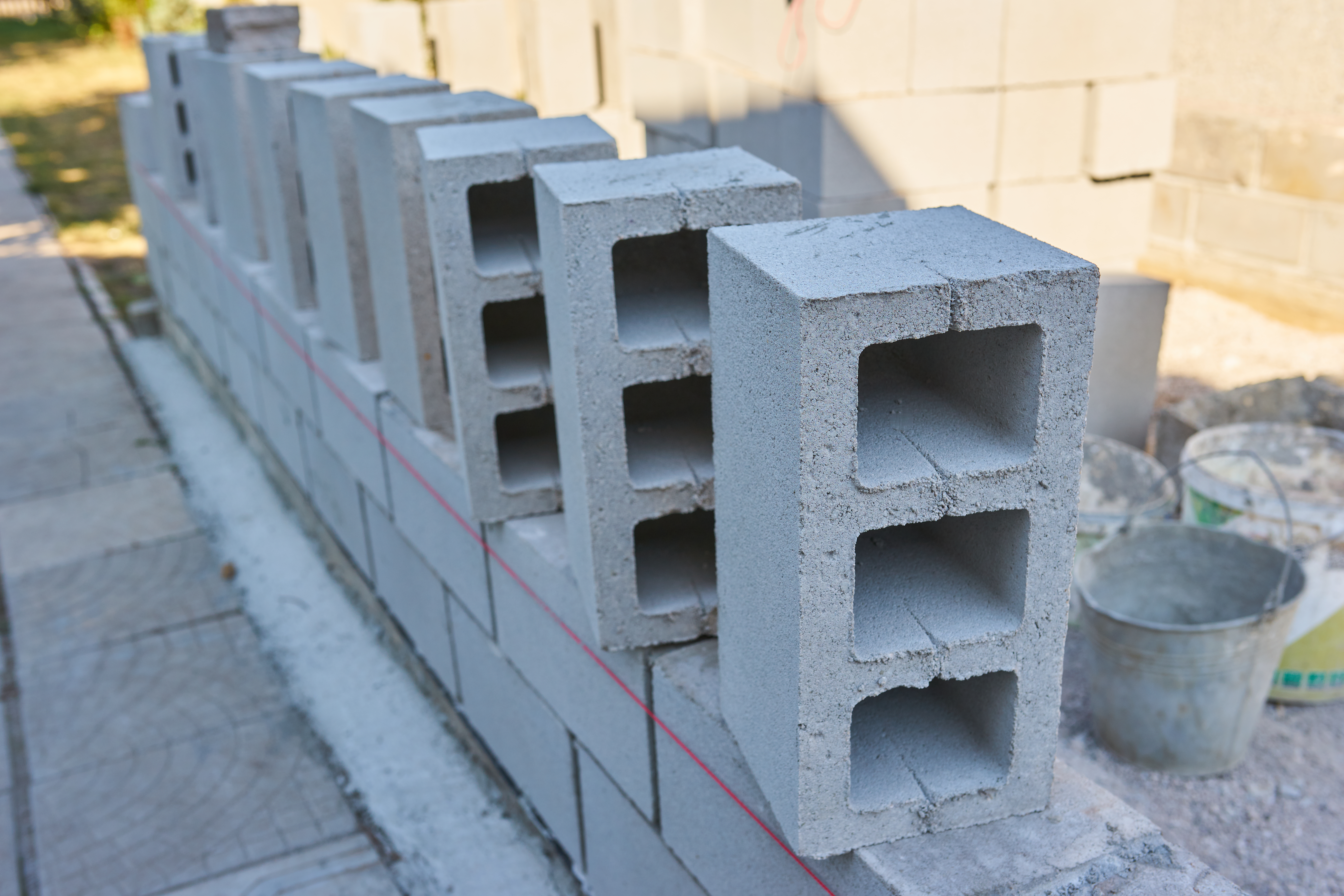 Home worker builds a cinder block wall for a new home